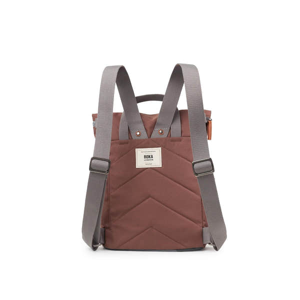Roka Finchley A Coco recycled canvas backpack with grey adjustable shoulder straps, front pocket, and white logo patch.