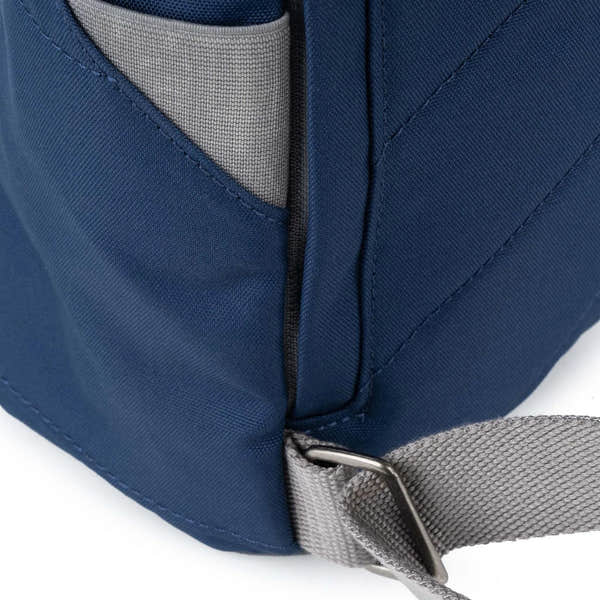 Roka Finchley blue recycled canvas backpack with grey strap and side pocket, durable and eco-friendly design.
