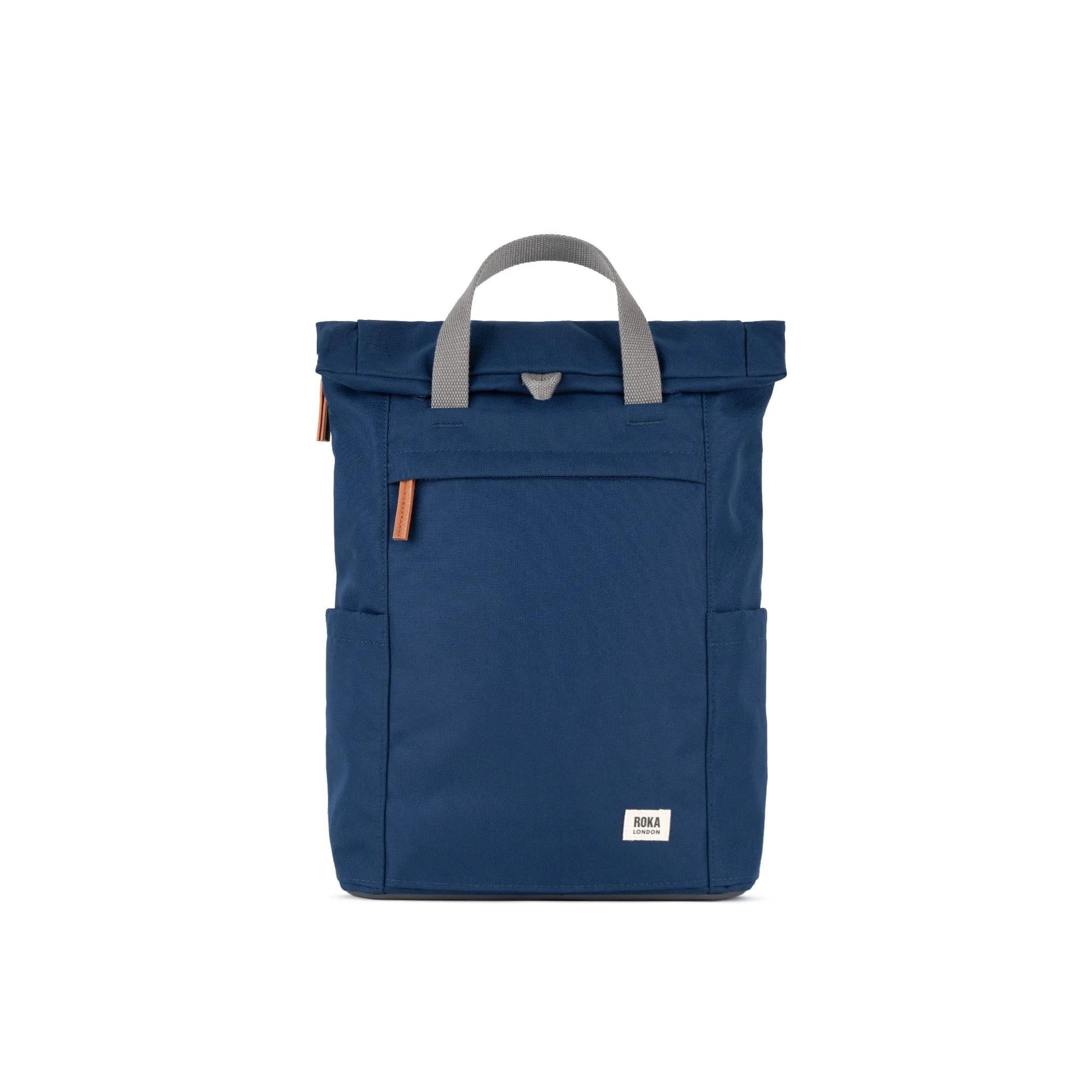 Roka Finchley blue recycled canvas backpack with grey handles and brown accents, compact and stylish.