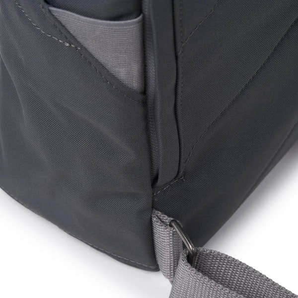 Roka Finchley A Faded Black Recycled Canvas backpack with adjustable strap and front pocket detail.