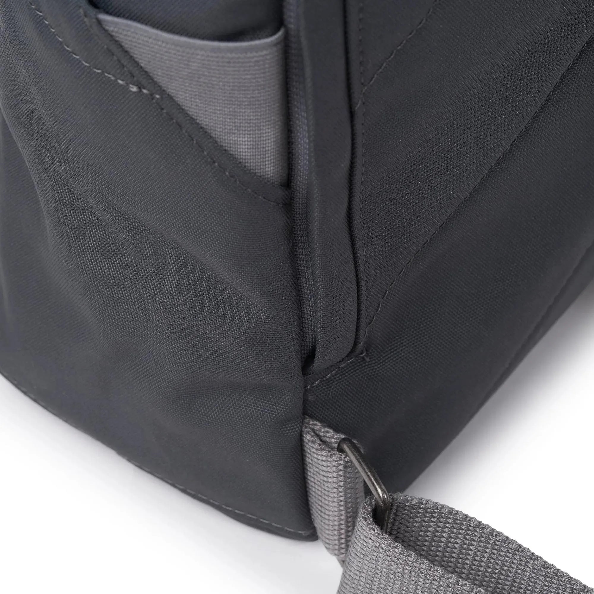 Roka Finchley A Faded Black Recycled Canvas backpack with adjustable strap and front pocket detail.
