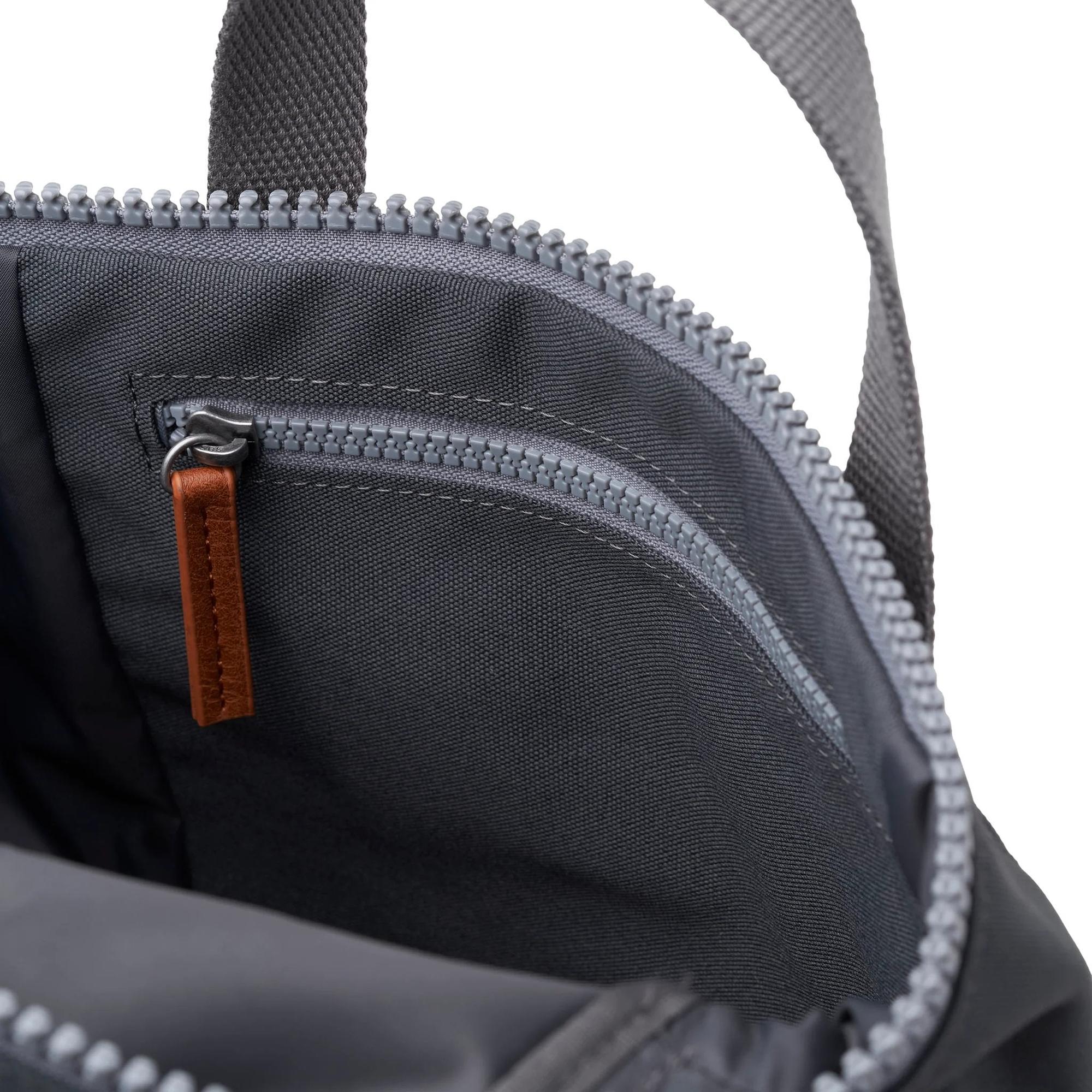 Roka Finchley A Faded Black Recycled Canvas backpack with zippered compartments and leather pull tab.