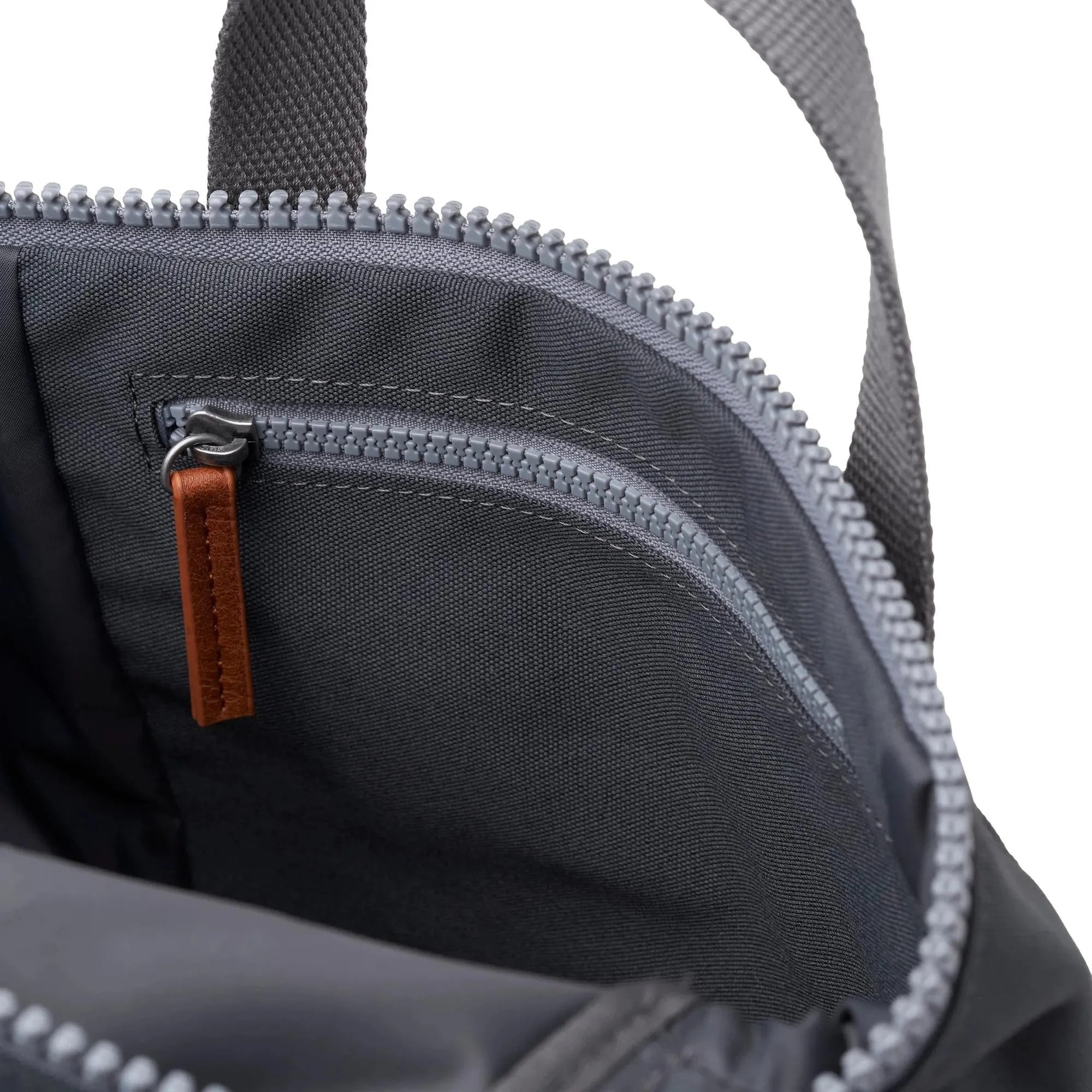 Roka Finchley A Faded Black Recycled Canvas backpack with zippered compartments and leather pull tab.