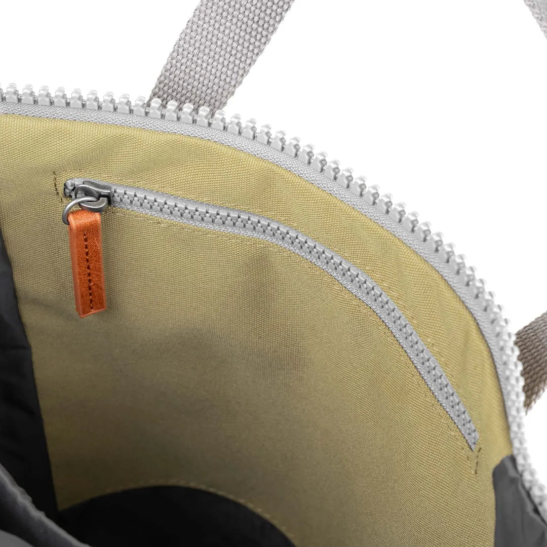 Roka Finchley A Khaki Recycled Canvas tote bag with zipper interior pocket and beige lining.