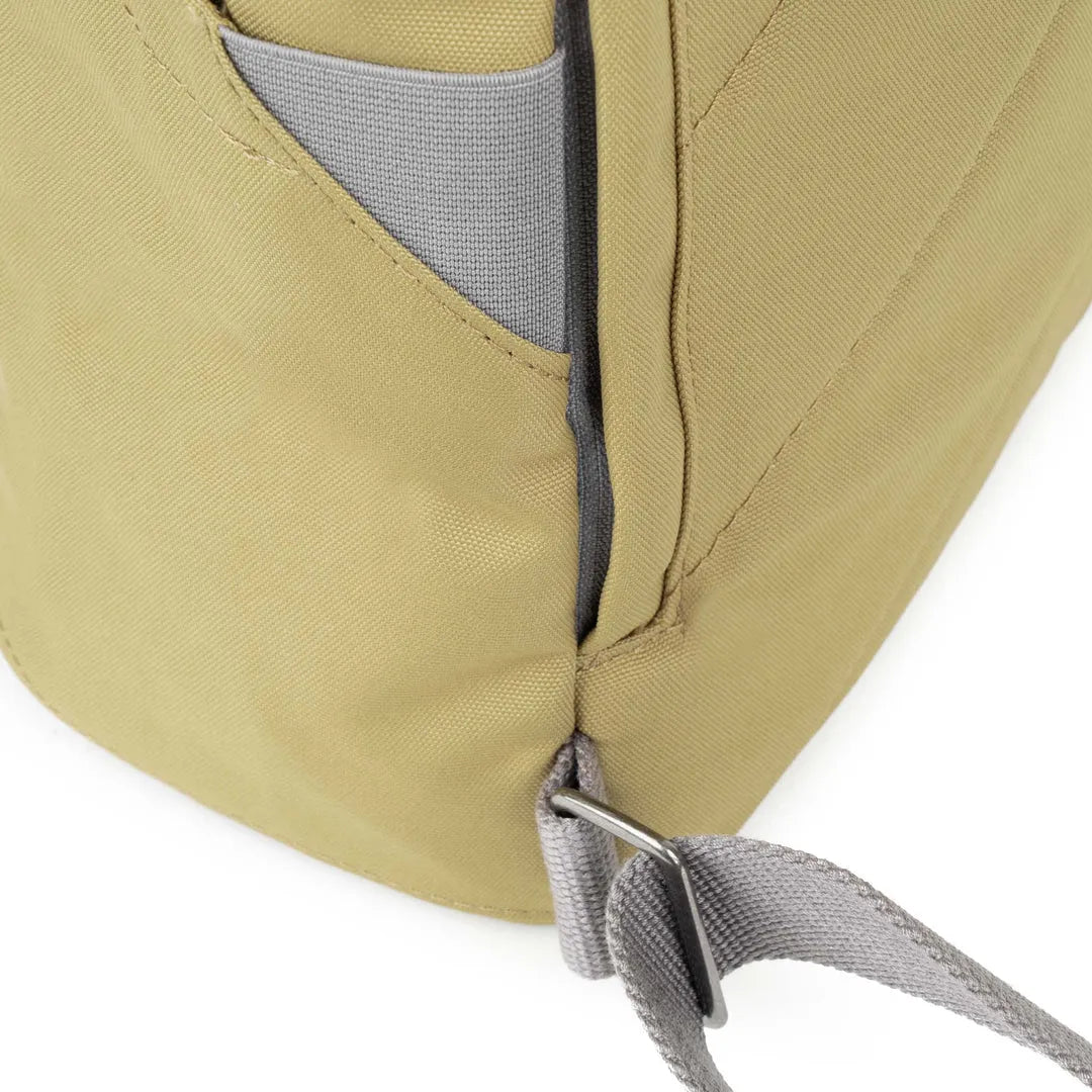 Roka Finchley A Khaki recycled canvas backpack with grey accents and adjustable strap detail.