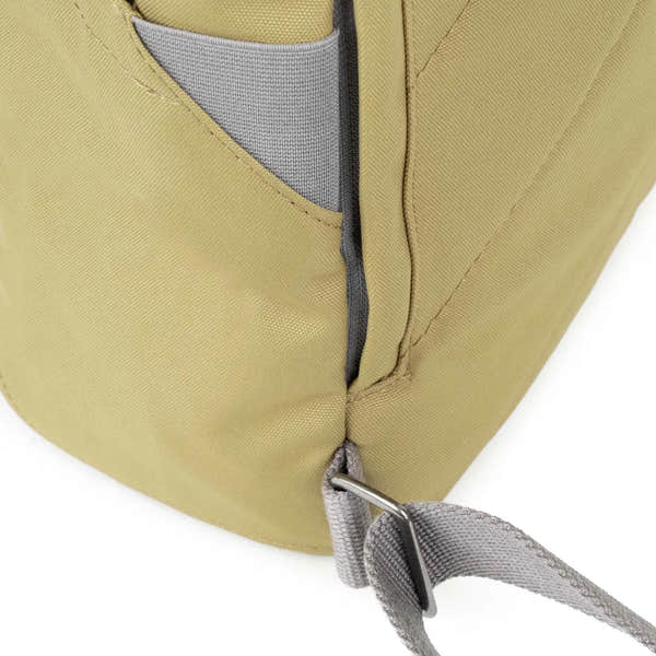 Roka Finchley A Khaki recycled canvas backpack with grey accents and adjustable strap detail.