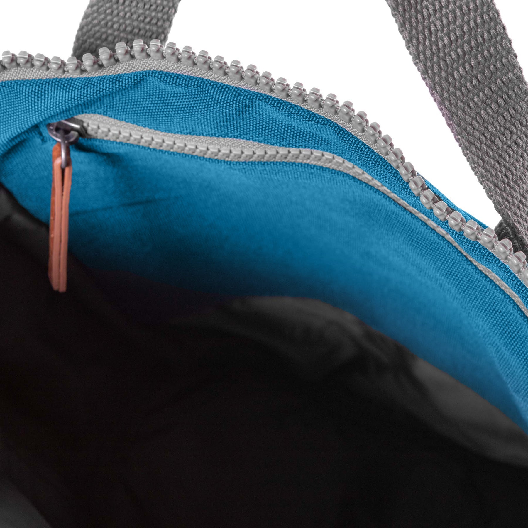 Close-up of Roka Finchley A Marine recycled canvas bag interior with blue lining, silver zipper, and grey fabric handles.