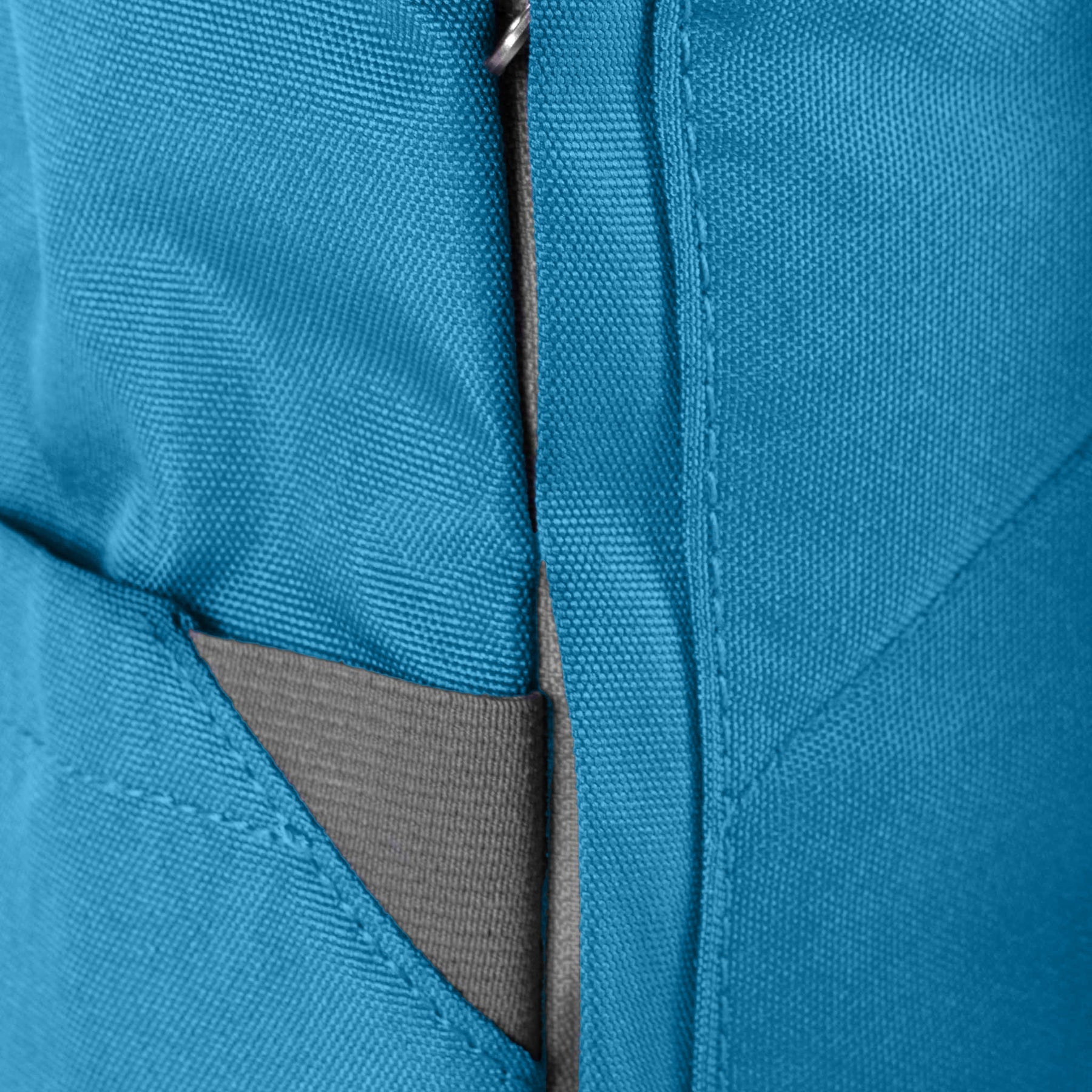 Close-up of a blue Roka Finchley A Marine recycled canvas backpack with gray accents and a zipper detail.