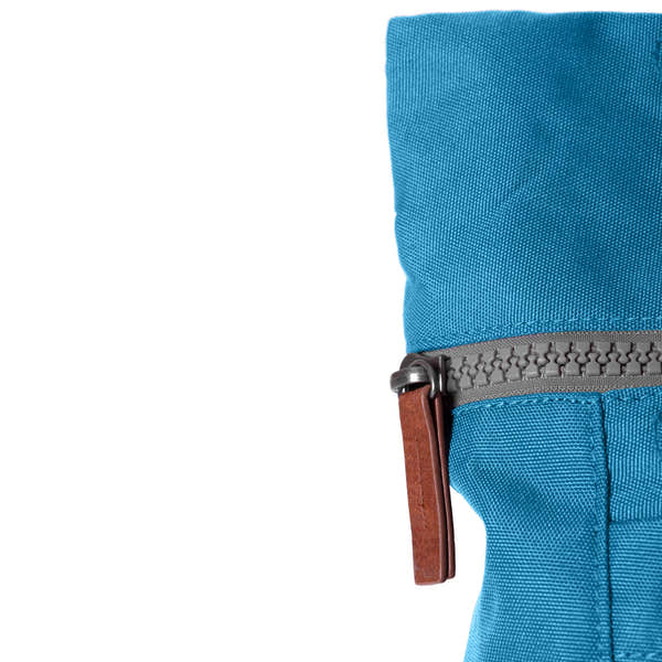 Roka Finchley A Marine recycled canvas backpack with blue fabric and gray zipper.