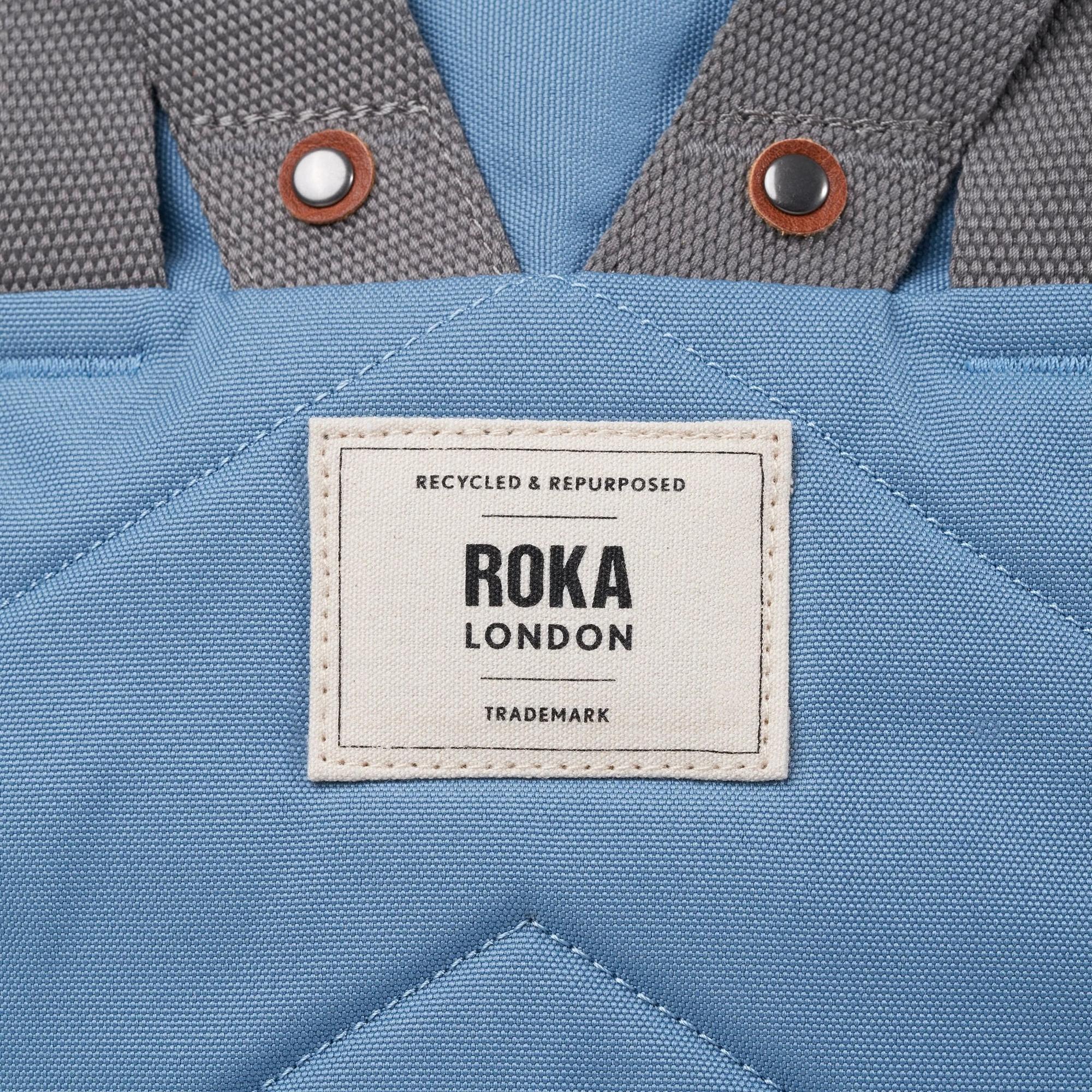 Roka Finchley A Retro Blue Recycled Canvas tote bag with brown accents and logo label.