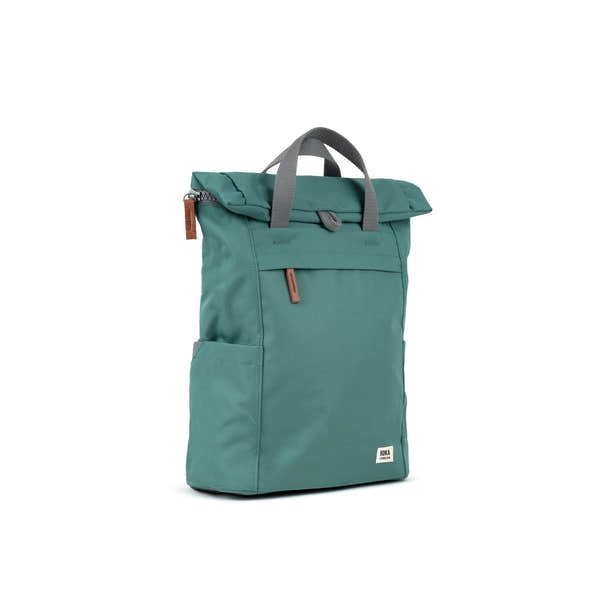 Roka Finchley A Sage Recycled Canvas backpack, fold-over top, front zip pocket, side pocket, gray handles, white logo tag.