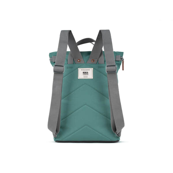 Roka Finchley A Sage Recycled Canvas backpack with gray adjustable straps and front patch logo.
