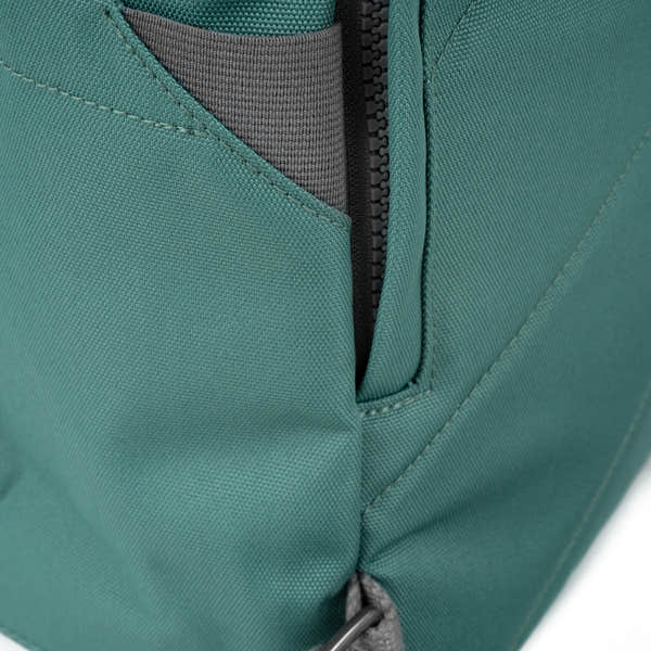 Roka Finchley A Sage recycled canvas backpack with zipper pocket detail and grey interior lining.