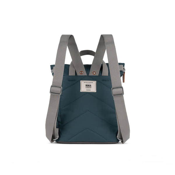 Roka Finchley A Smoke recycled canvas backpack with grey straps, front logo patch, and multiple compartments, eco-friendly design.