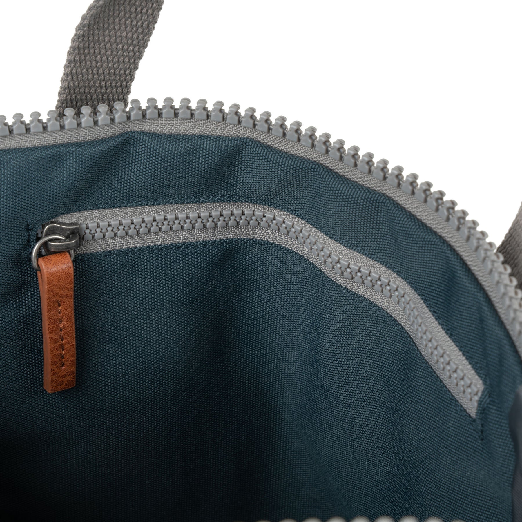 Close-up of Roka Finchley A Smoke recycled canvas tote bag interior with zipper pocket and leather pull tab.