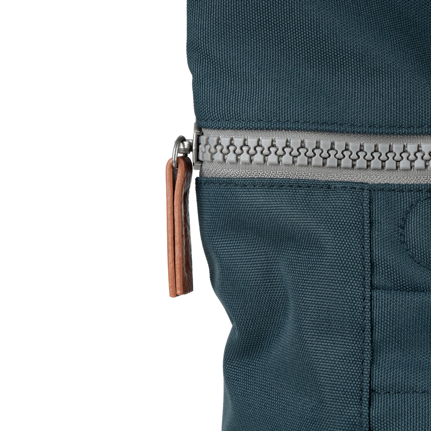 Roka Finchley A Smoke recycled canvas backpack, close-up of zipper with leather pull tab, in dark teal color.
