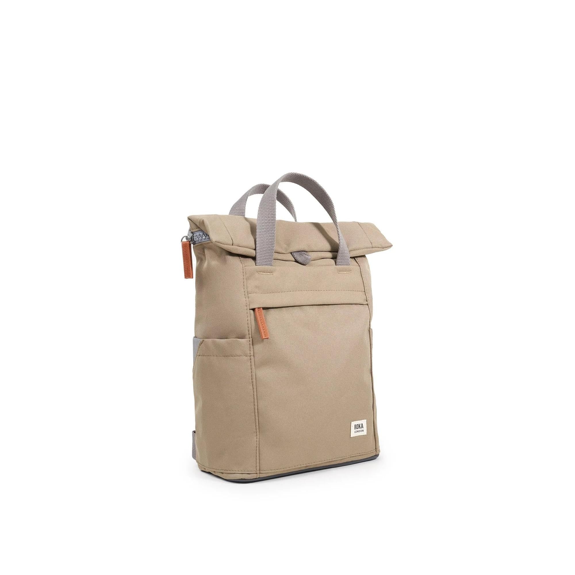 Roka Finchley A Taupe recycled canvas backpack with front pocket, grey handles, and orange zipper pulls.