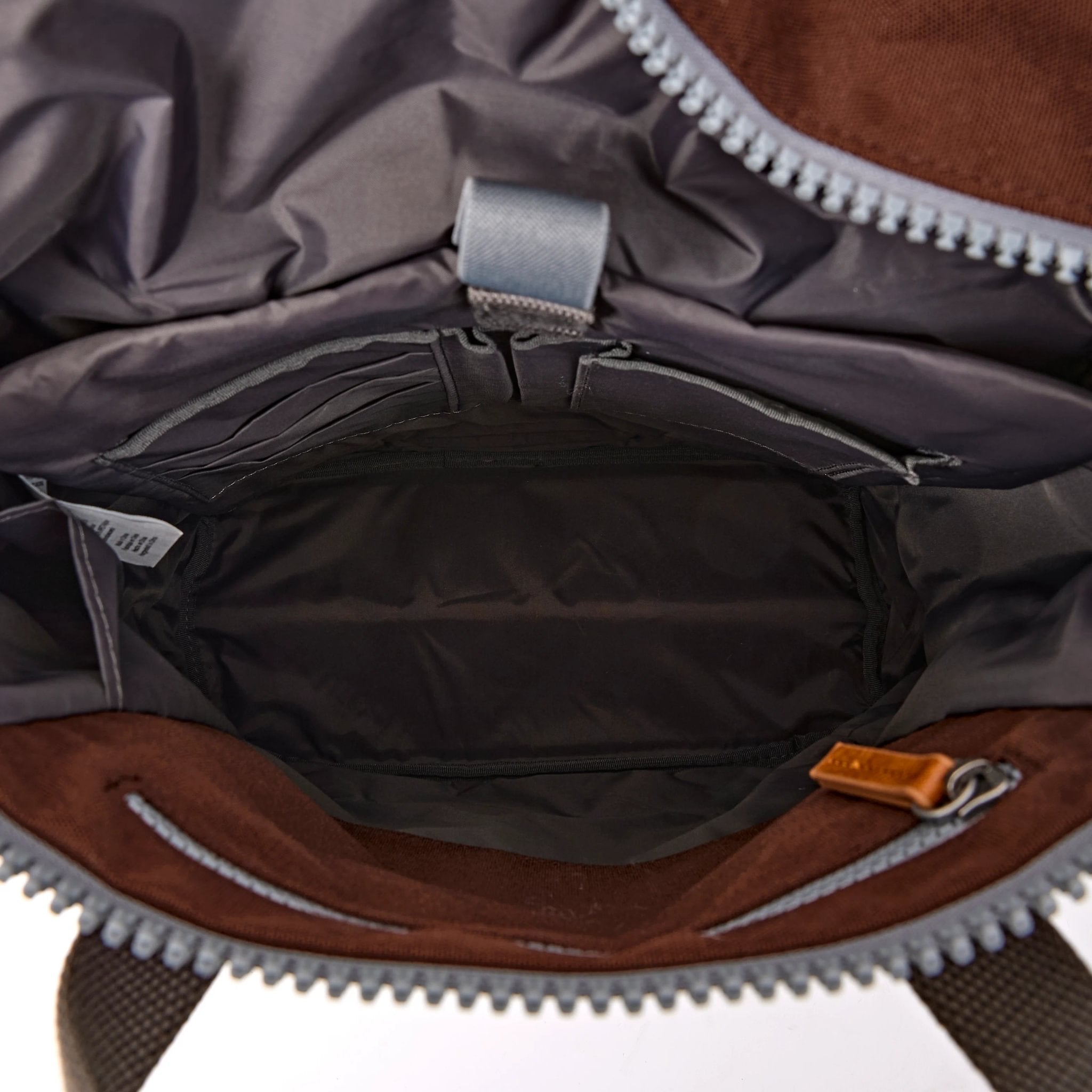 Roka Finchley Medium Chocolate Recycled Canvas Backpack, side view.