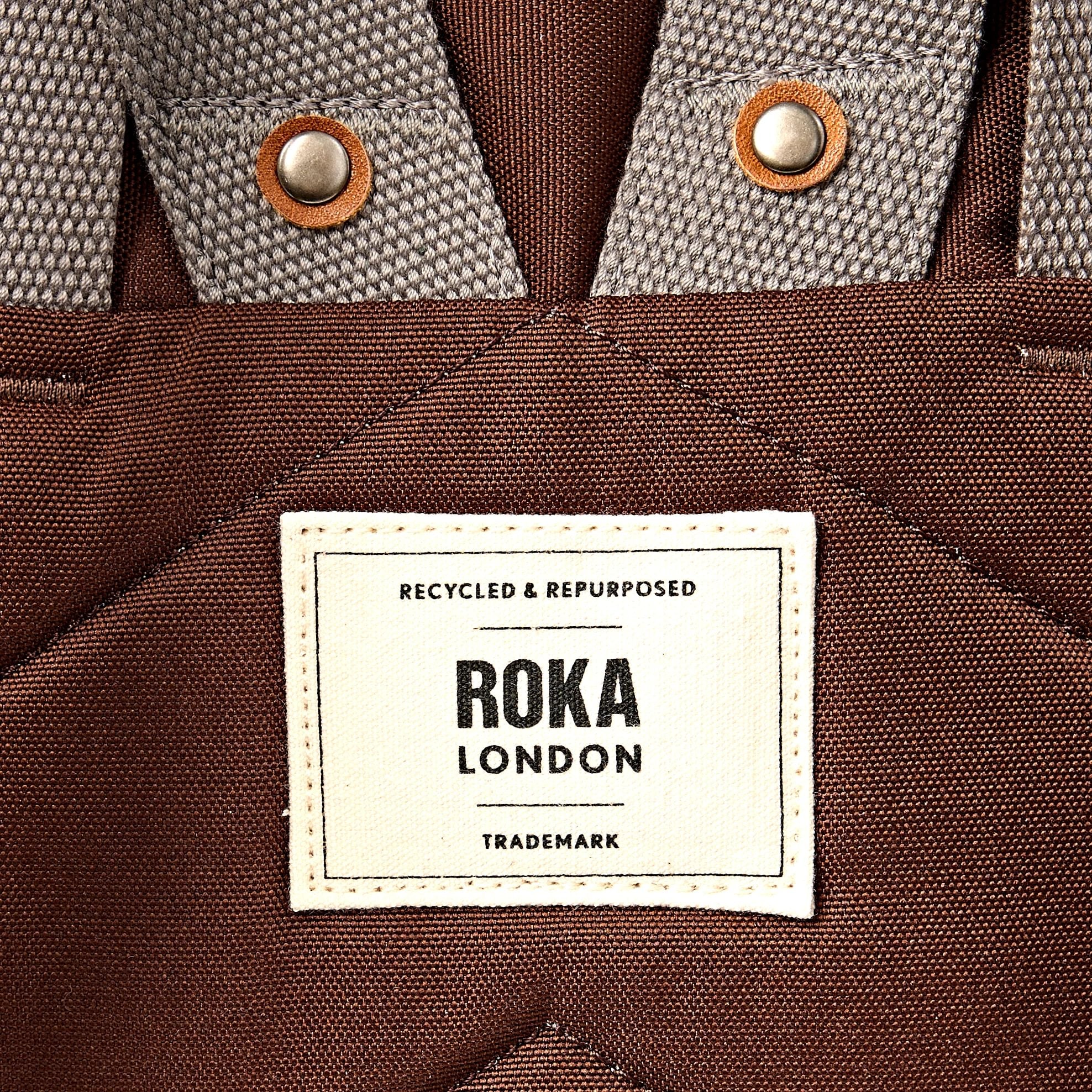 Roka Finchley Medium Chocolate Recycled Canvas Backpack, brand label detail.