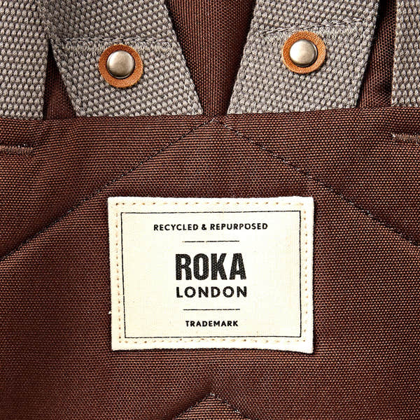 Roka Finchley Medium Chocolate Recycled Canvas Backpack, brand label detail.