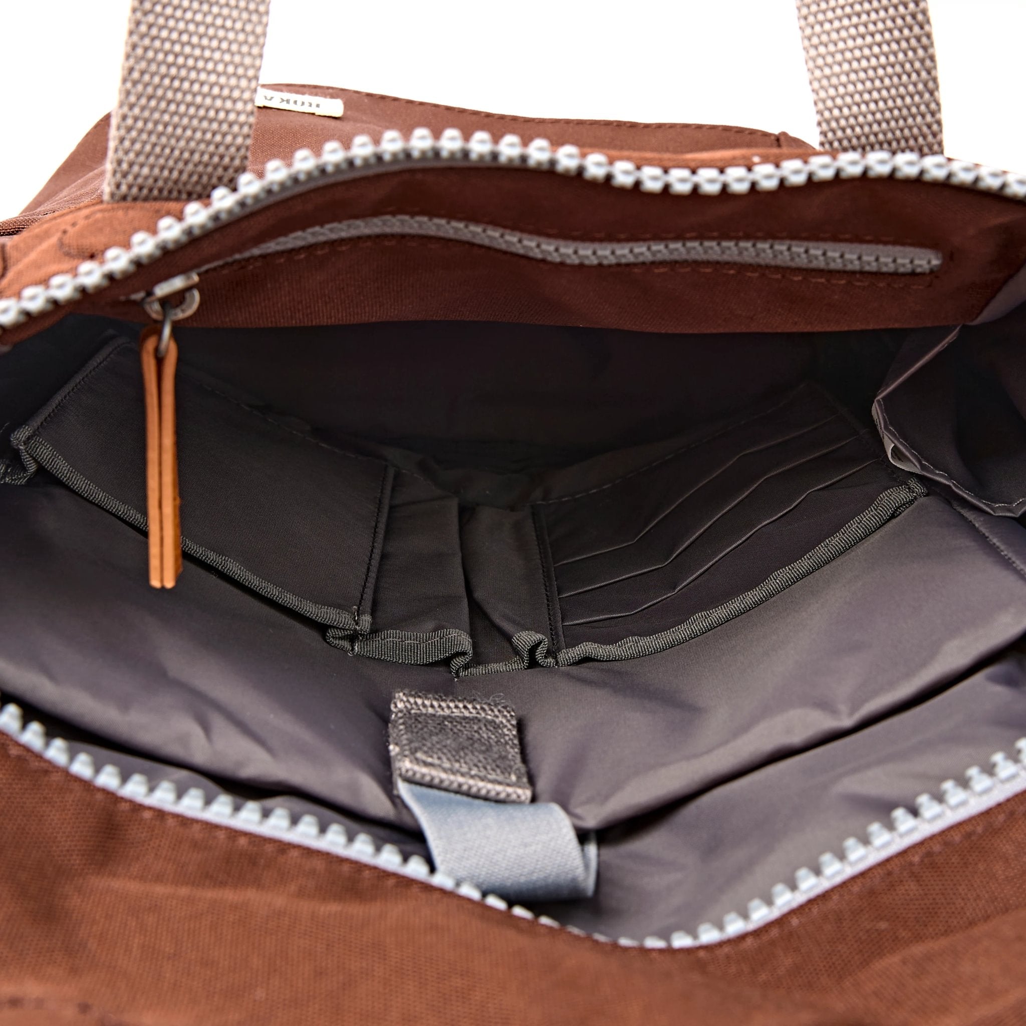 Roka Finchley Small Chocolate Recycled Canvas Backpack, side view.