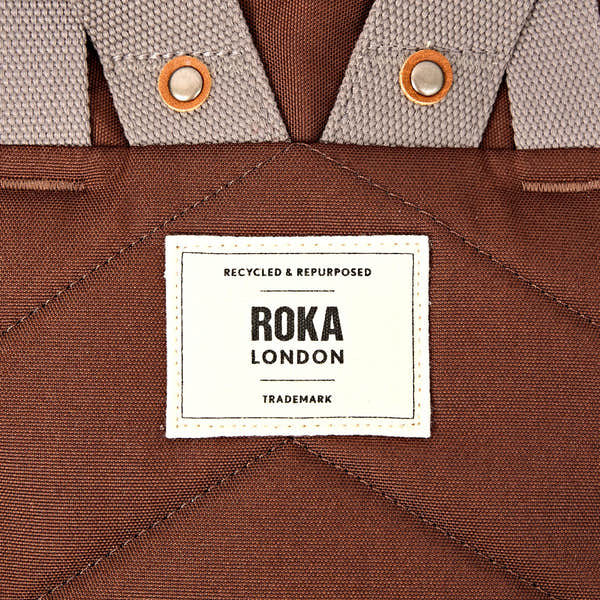 Roka Finchley Small Chocolate Recycled Canvas Backpack, brand label detail.