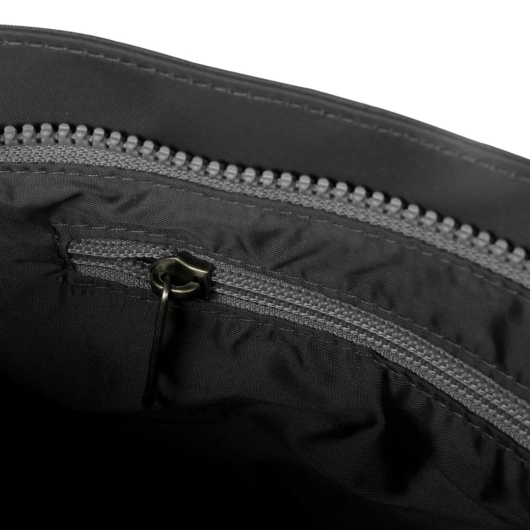 Roka Kennington B Crossbody recycled nylon bag in graphite with zippered interior pocket and durable black material.