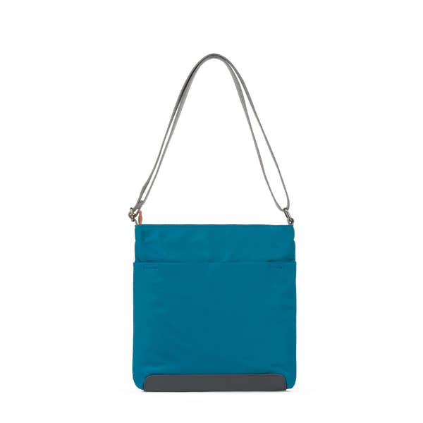 Roka Kennington B Crossbody Bag in recycled nylon, sapphire blue with gray shoulder strap and black base.