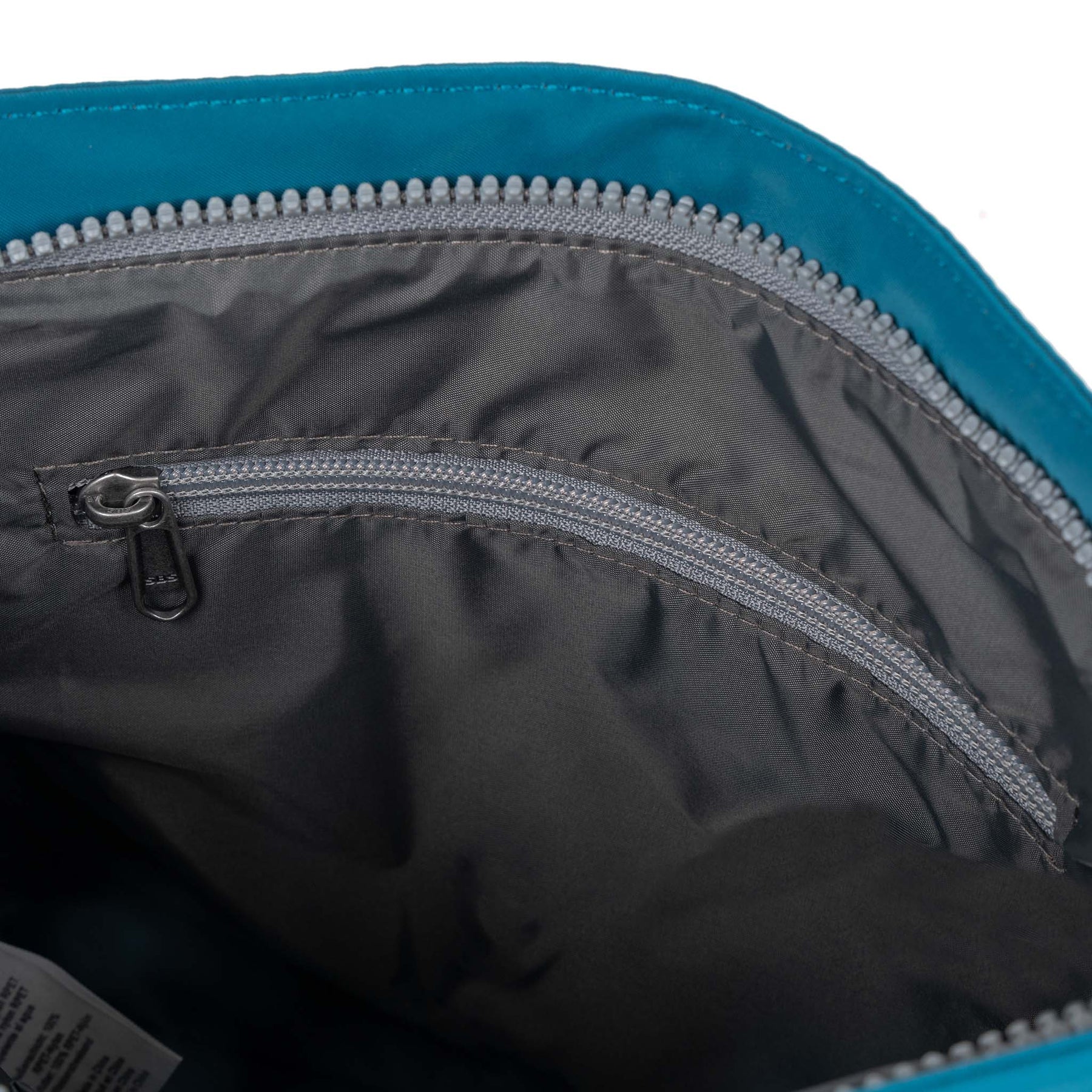 Roka Kennington B Crossbody bag in recycled nylon Sapphire with interior zip pocket and grey lining.