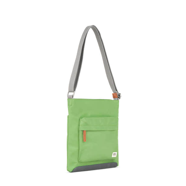 Roka Kennington B Kiwi recycled nylon shoulder bag with front zip pocket and adjustable strap.