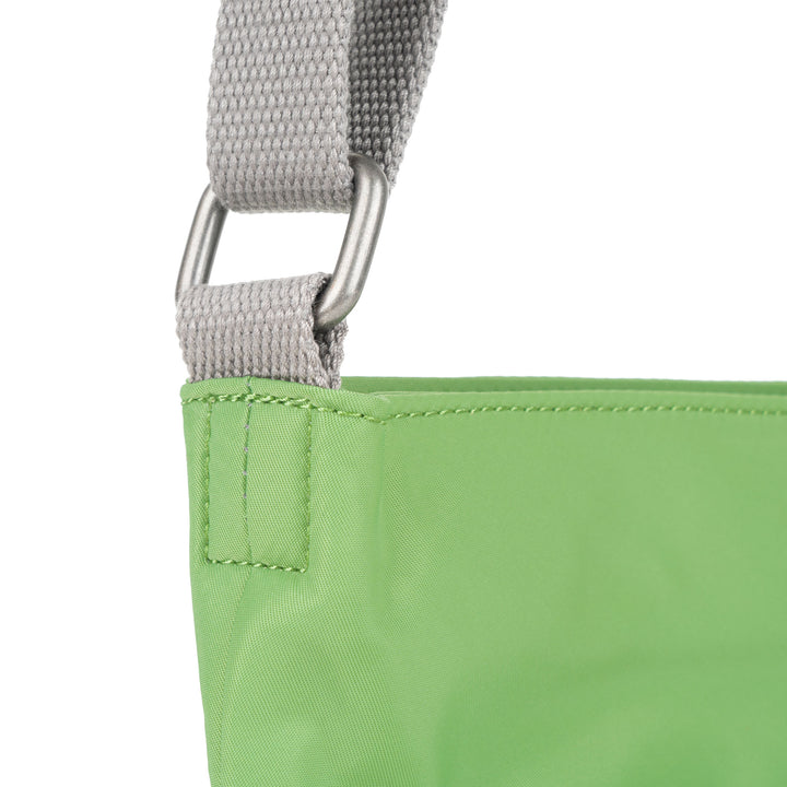 Roka Kennington B Kiwi recycled nylon bag with gray strap and silver hardware detail.