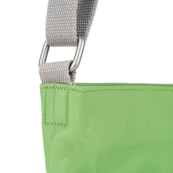 Roka Kennington B Kiwi recycled nylon bag with gray strap and silver hardware detail.