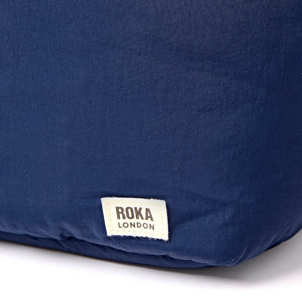 Roka Oxford Deep Cobalt Recycled Taslon Shoulder Bag, brand label detail.