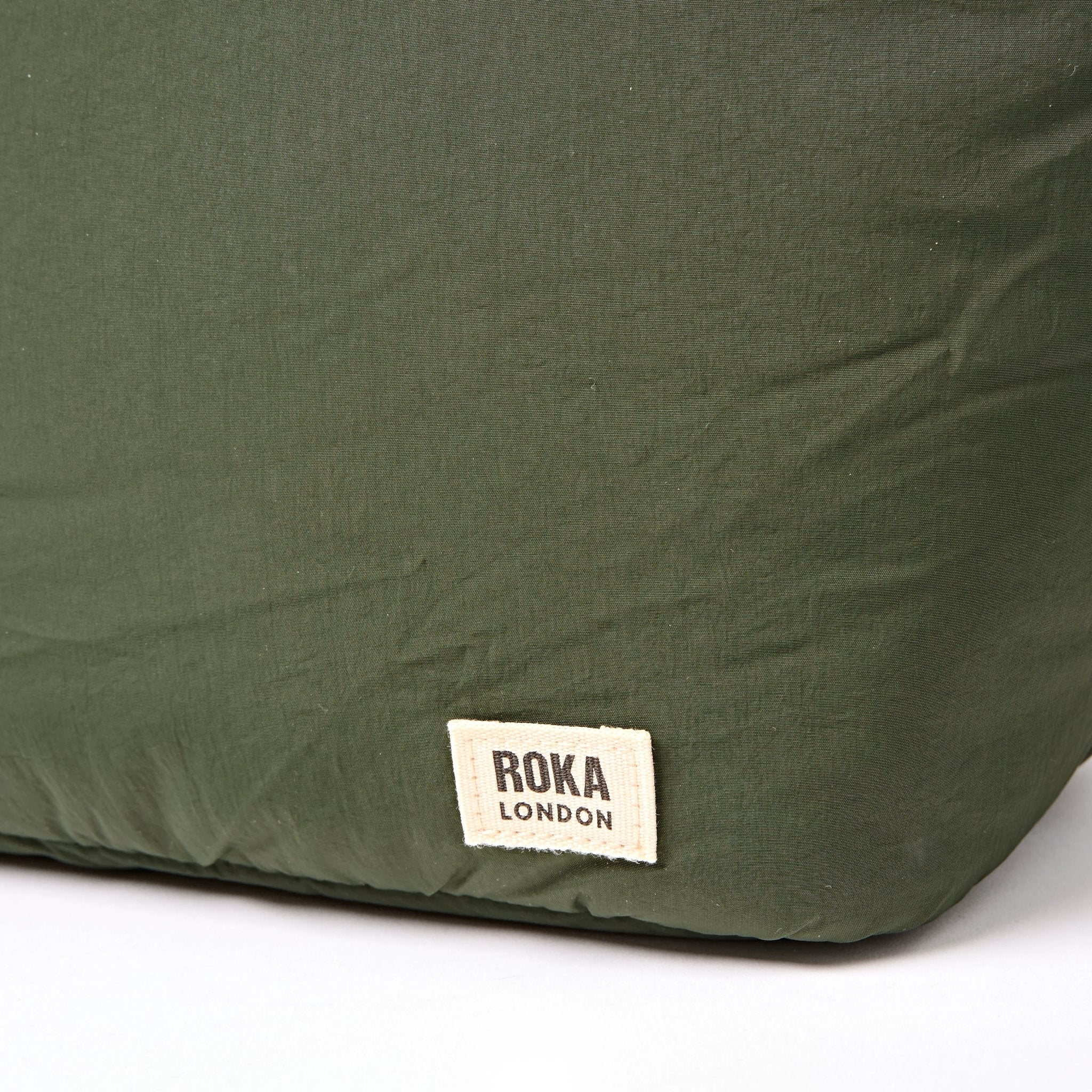 Roka Oxford Olive Recycled Taslon Shoulder Bag, brand label detail.