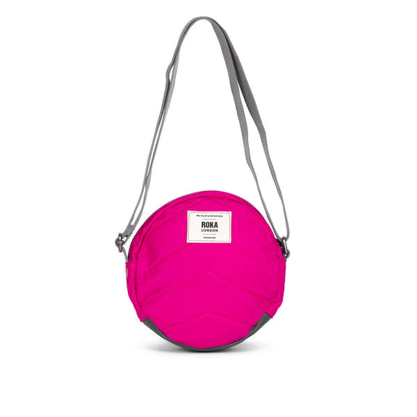 Roka Paddington B Candy small recycled nylon crossbody bag in bright pink with grey adjustable strap.