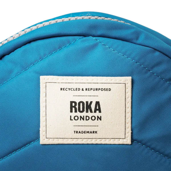Roka Paddington B Seaport small backpack made of recycled nylon, blue color with Roka London label, eco-friendly and durable.