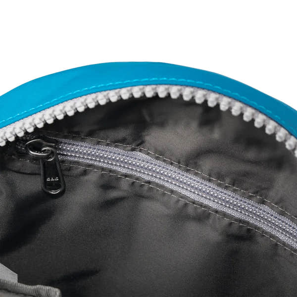 Roka Paddington B Seaport small recycled nylon bag interior with black lining and silver zipper pocket.