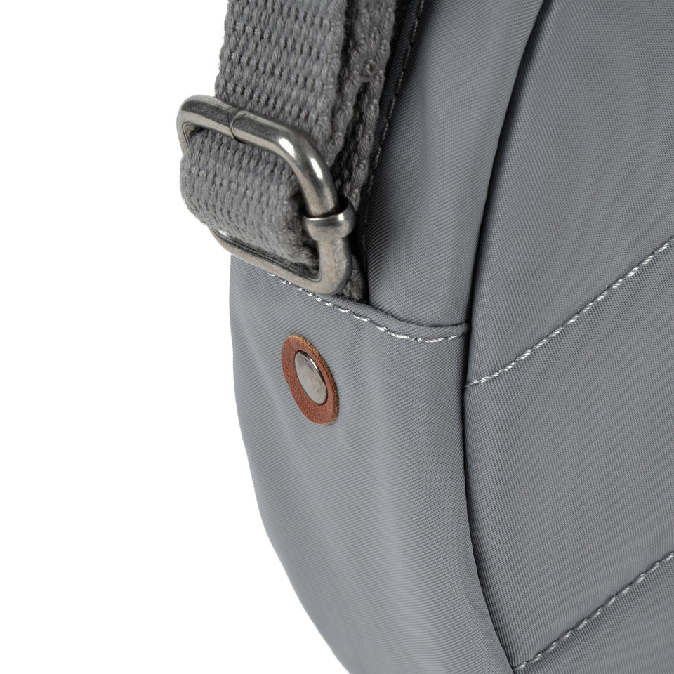 Roka Paddington B Stormy Small backpack made of recycled nylon, gray color, with metal hardware and detailed stitching.