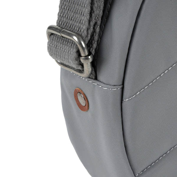 Roka Paddington B Stormy Small backpack made of recycled nylon, gray color, with metal hardware and detailed stitching.