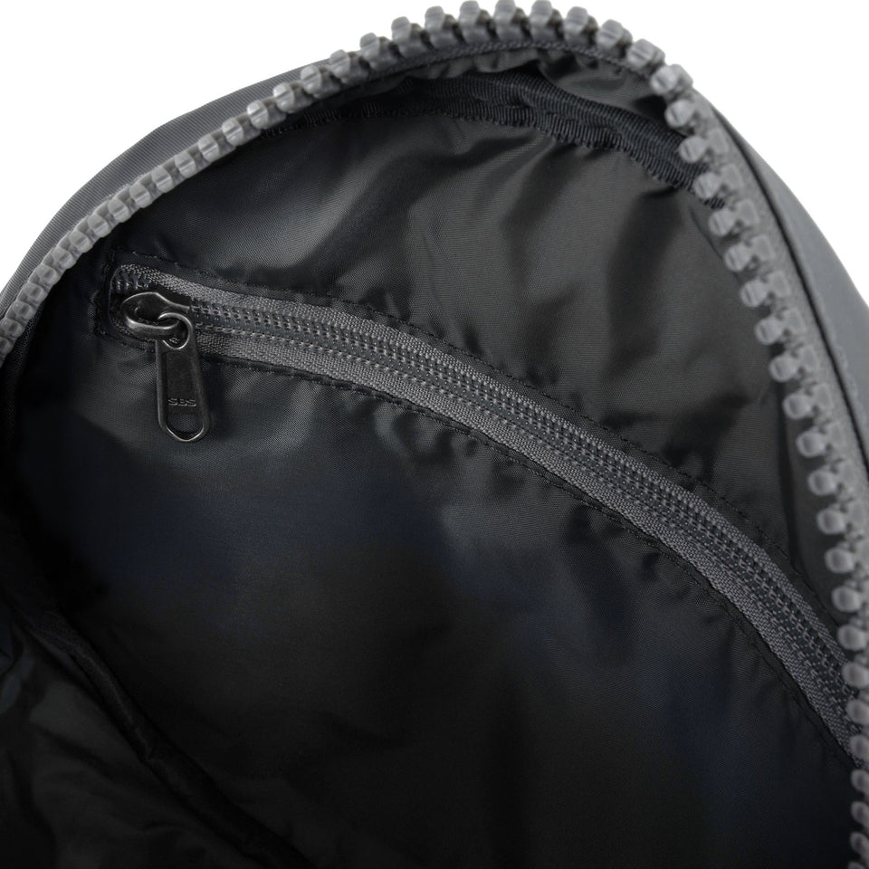 Roka Paddington B Stormy Small Recycled Nylon backpack interior with zippered pocket, black interior lining.