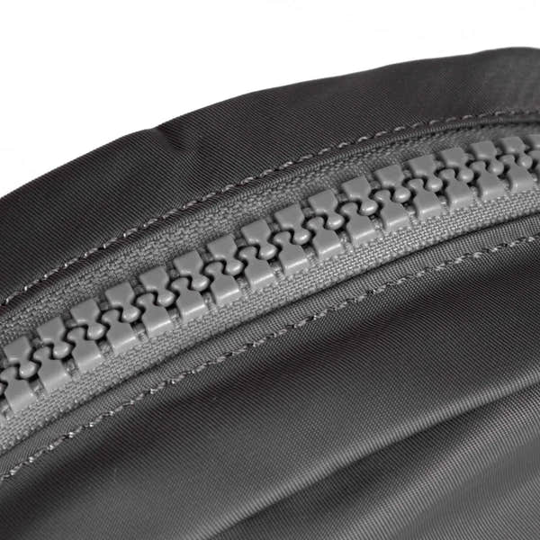 Roka Paddington B Graphite small recycled nylon backpack with a close-up of gray zipper and durable fabric.
