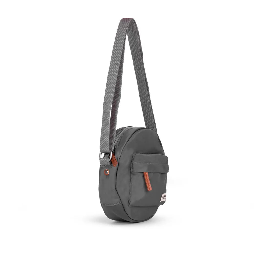 Roka Paddington B Graphite small recycled nylon shoulder bag with front pocket and adjustable strap, eco-friendly travel accessory.