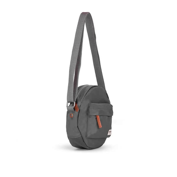 Roka Paddington B Graphite small recycled nylon shoulder bag with front pocket and adjustable strap, eco-friendly travel accessory.