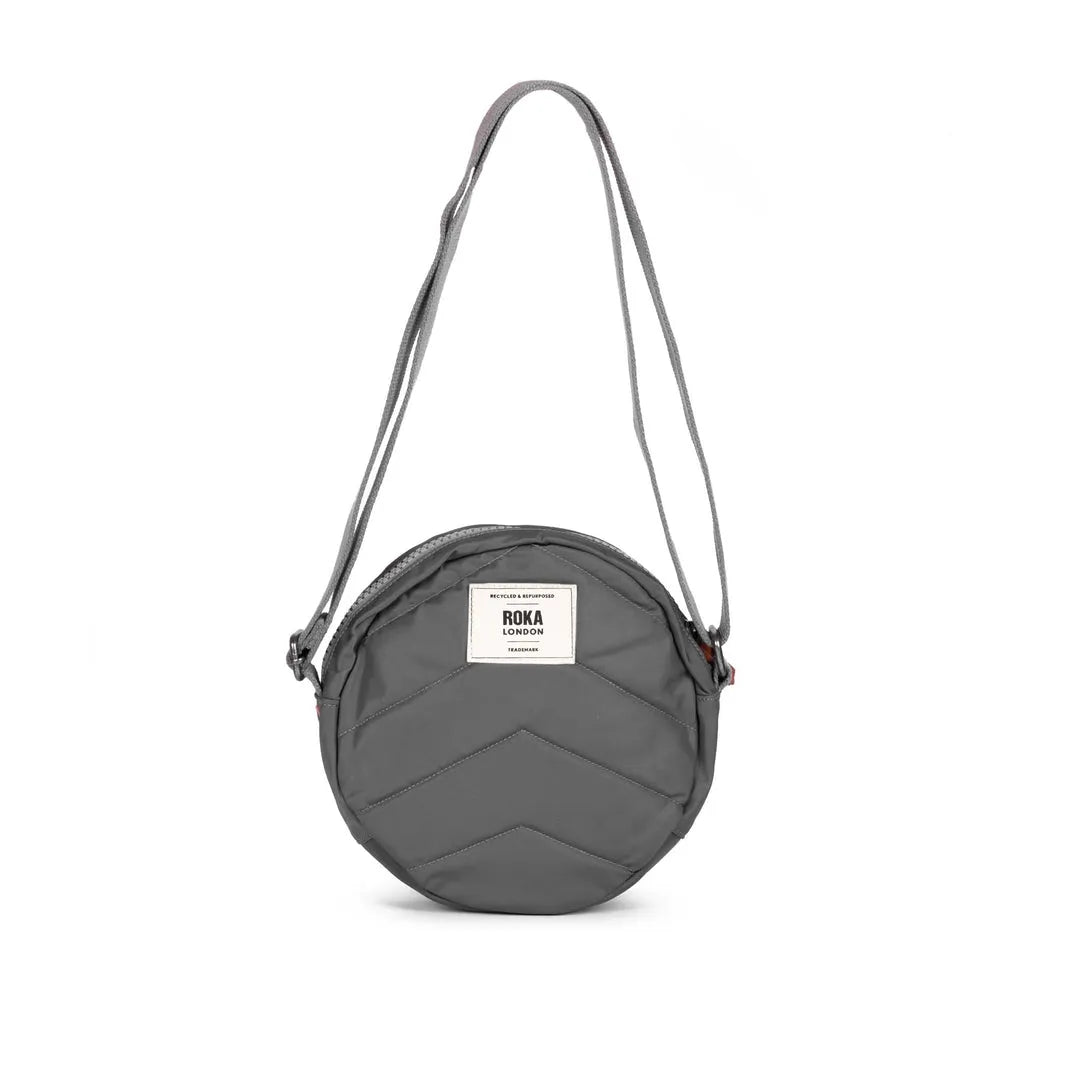 Roka Paddington B Graphite small recycled nylon crossbody bag with chevron pattern and adjustable strap.