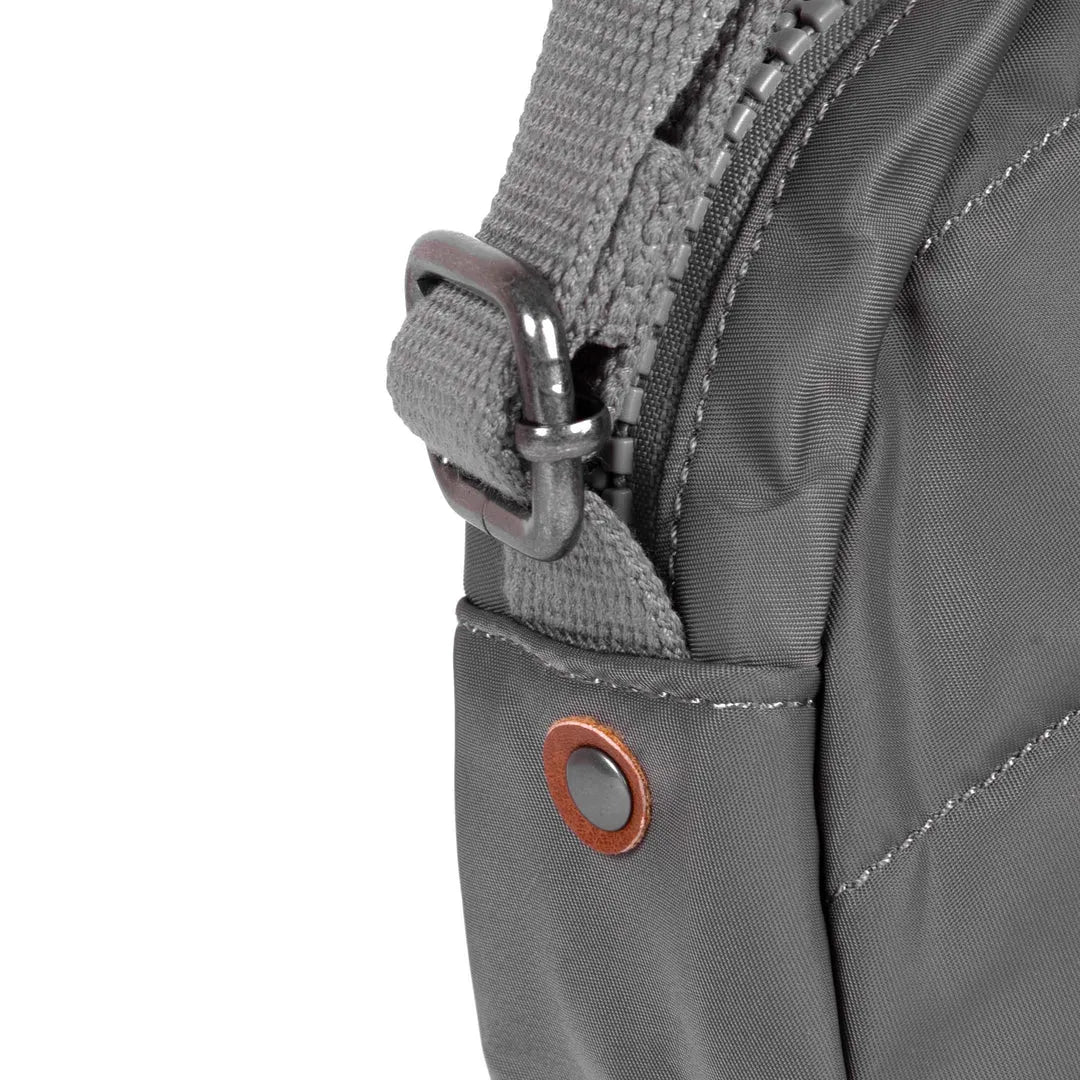 Roka Paddington B Graphite small recycled nylon backpack with adjustable strap, metal buckle, and stitched details.