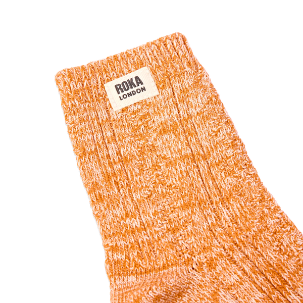 Roka Wallace Crew Socks for Women in Burnt Orange — ribbed cuff and logo close-up.