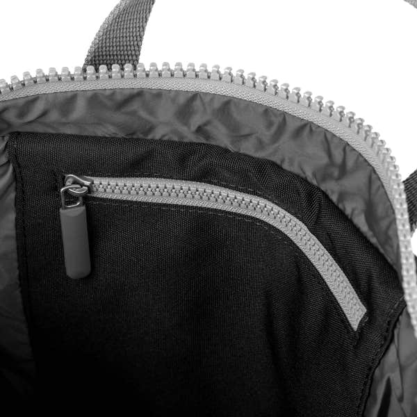 Roka Waterhouse Recycled Canvas Ash backpack interior with zippered pocket, black and gray fabric details.