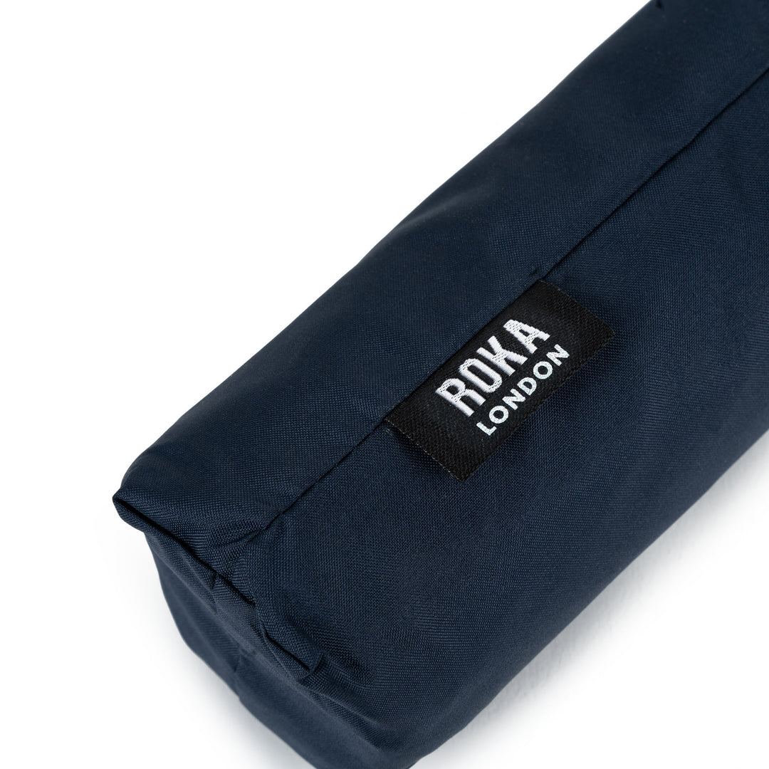 Roka Waterloo Midnight Recycled Nylon bag with black label, navy blue color, durable eco-friendly material, compact travel accessory.