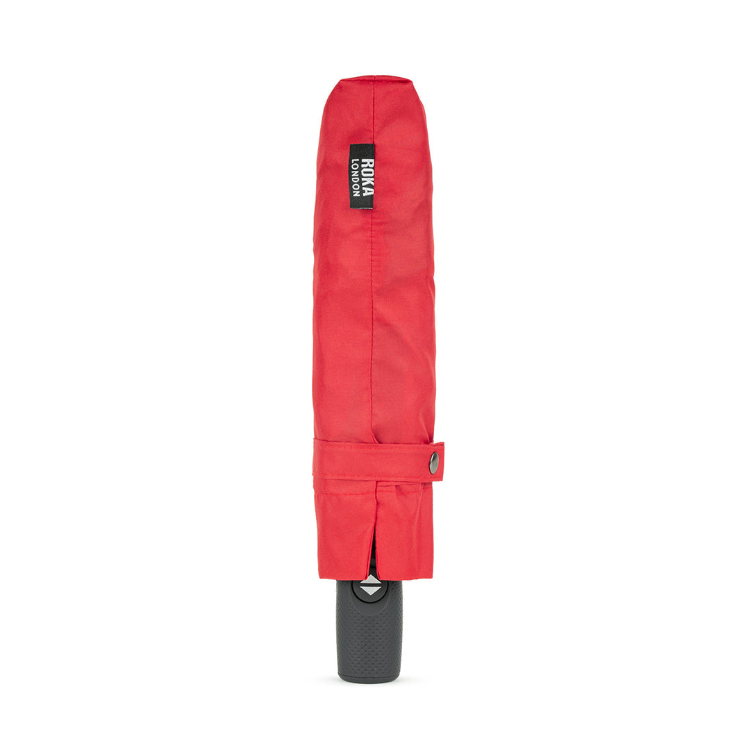 Roka Waterloo recycled polyester umbrella in cranberry/plum color with black handle and logo, compact and rain-resistant.