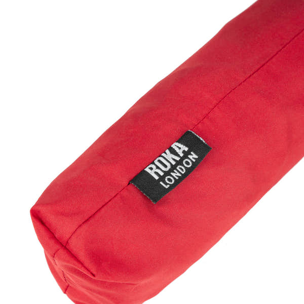Roka London recycled polyester umbrella in cranberry and plum color with black logo tag.